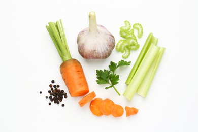 Photo of Fresh ripe carrot, vegetables and spices on white background, flat lay