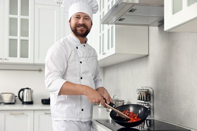 Photo of Professional chef cooking delicious food on stove in kitchen