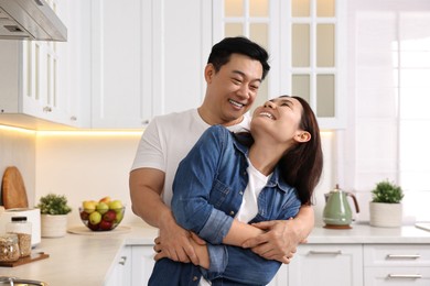 Lovely couple enjoying time together while cooking in kitchen