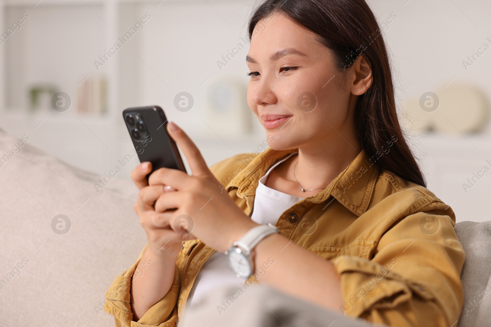 Photo of Portrait of beautiful woman with smartphone at home