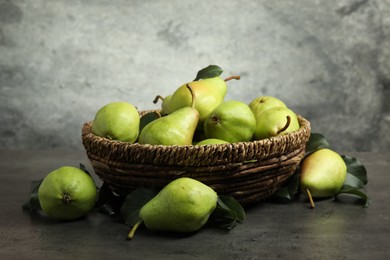 Photo of Many fresh ripe pears on grey table