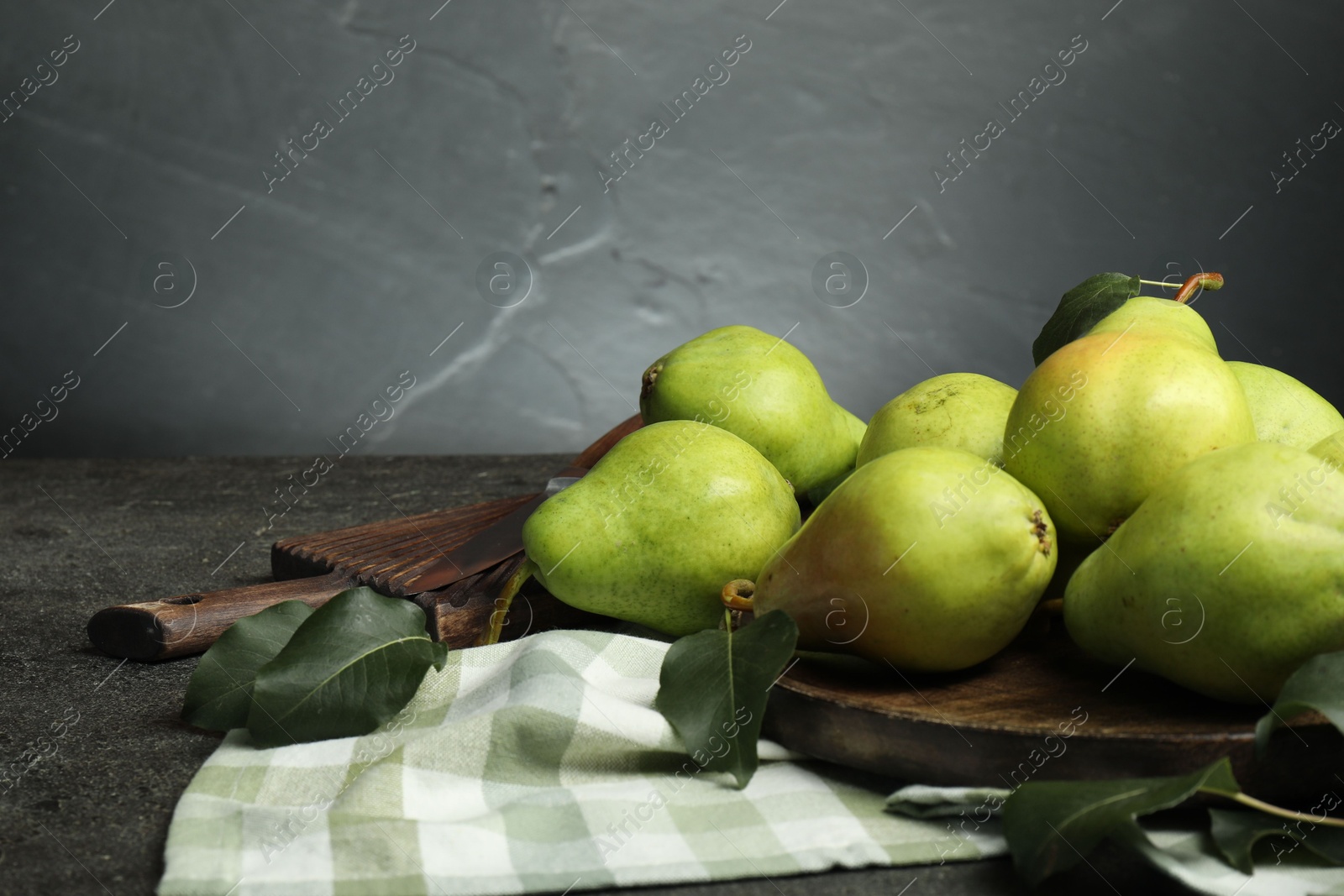 Photo of Many fresh ripe pears on grey table