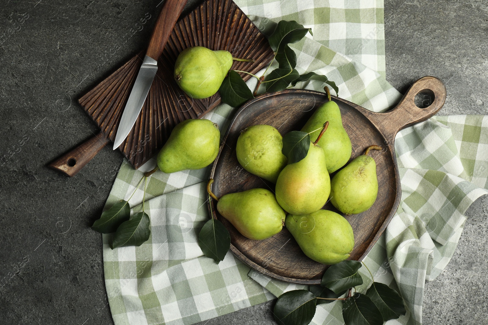 Photo of Many fresh ripe pears and knife on grey table, top view