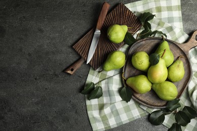 Photo of Many fresh ripe pears and knife on grey table, top view. Space for text