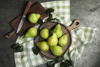 Photo of Many fresh ripe pears and knife on grey table, top view