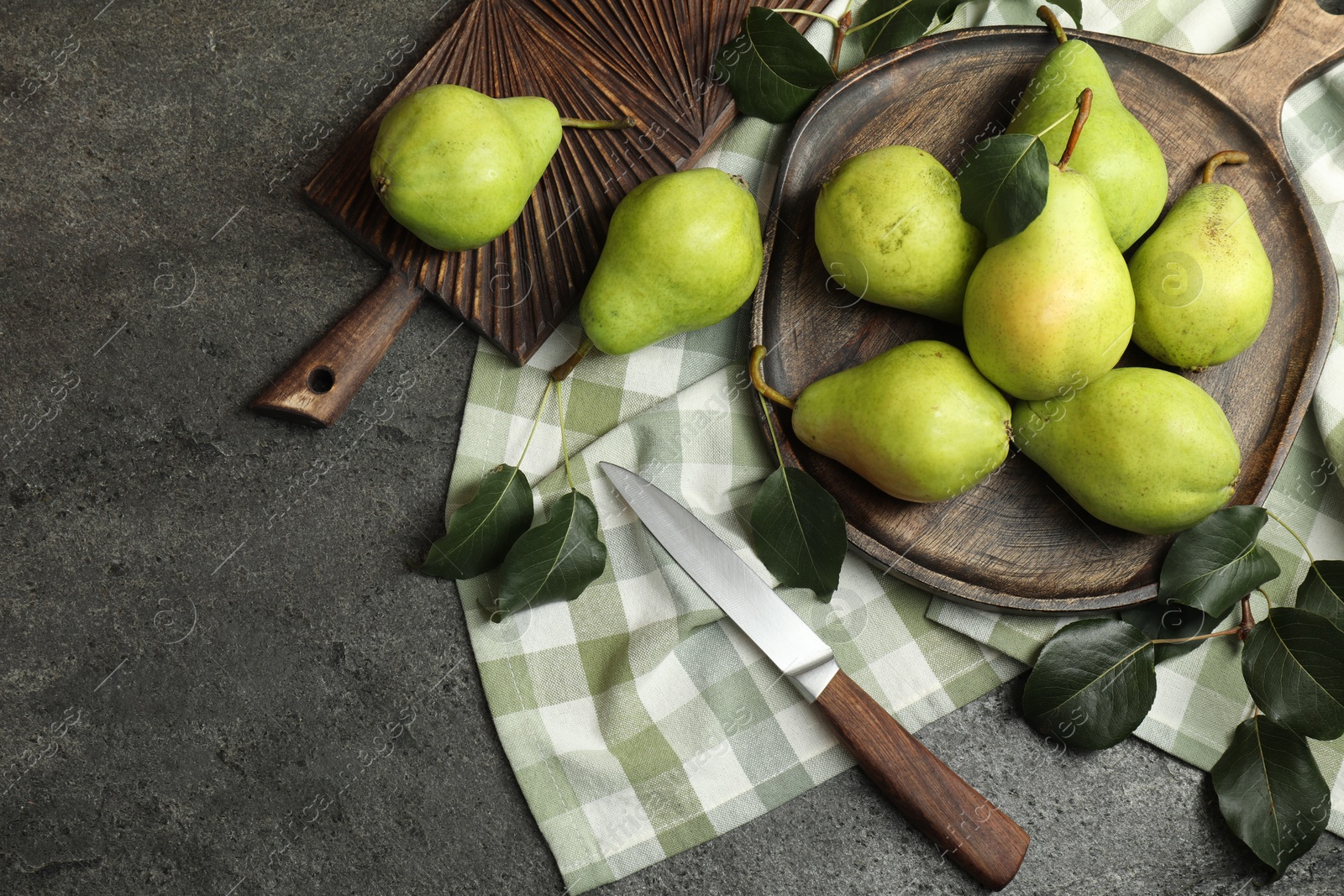 Photo of Many fresh ripe pears and knife on grey table, top view