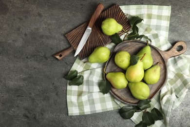 Photo of Many fresh ripe pears and knife on grey table, top view. Space for text