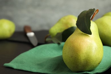 Photo of Fresh ripe pears on black table, closeup