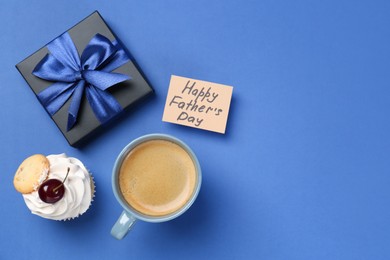 Photo of Card with phrase Happy Father's Day, gift box, cupcake and cup with coffee on blue background, flat lay. Space for text