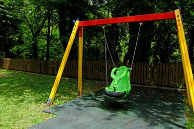 Colorful swing in park at summer. Playground equipment