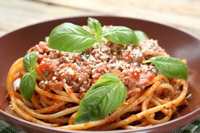 Photo of Delicious pasta bolognese with basil on table, closeup