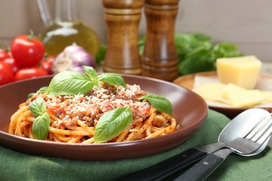 Photo of Delicious pasta bolognese with basil served on table, closeup