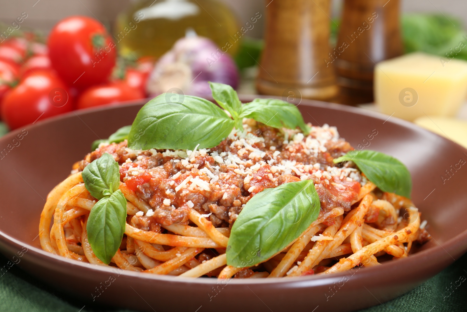 Photo of Delicious pasta bolognese with basil on table, closeup