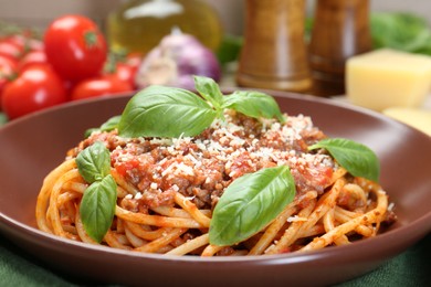 Photo of Delicious pasta bolognese with basil on table, closeup