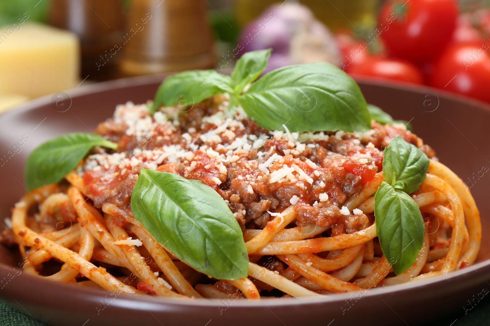 Photo of Delicious pasta bolognese with basil on table, closeup