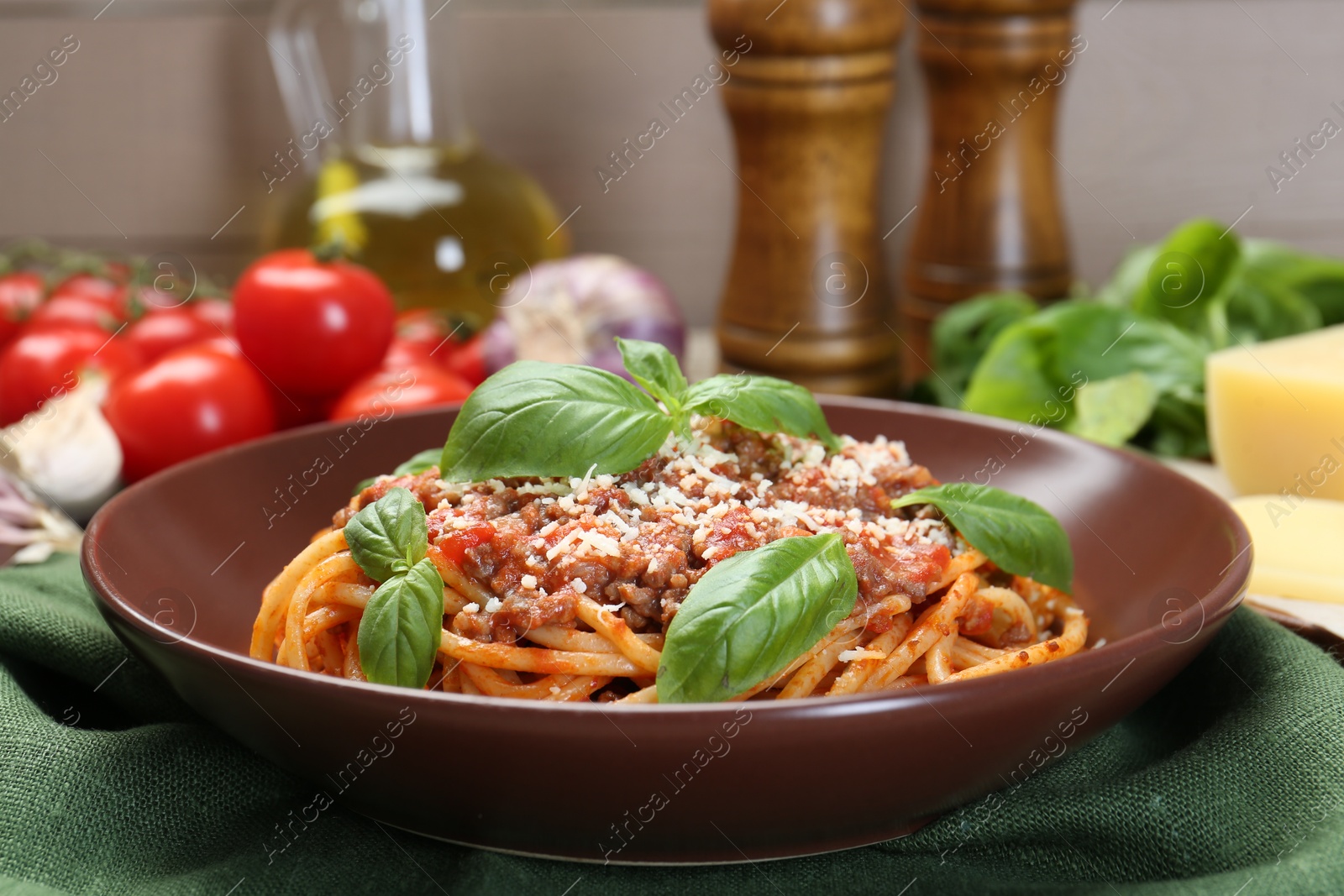 Photo of Delicious pasta bolognese with basil on table, closeup