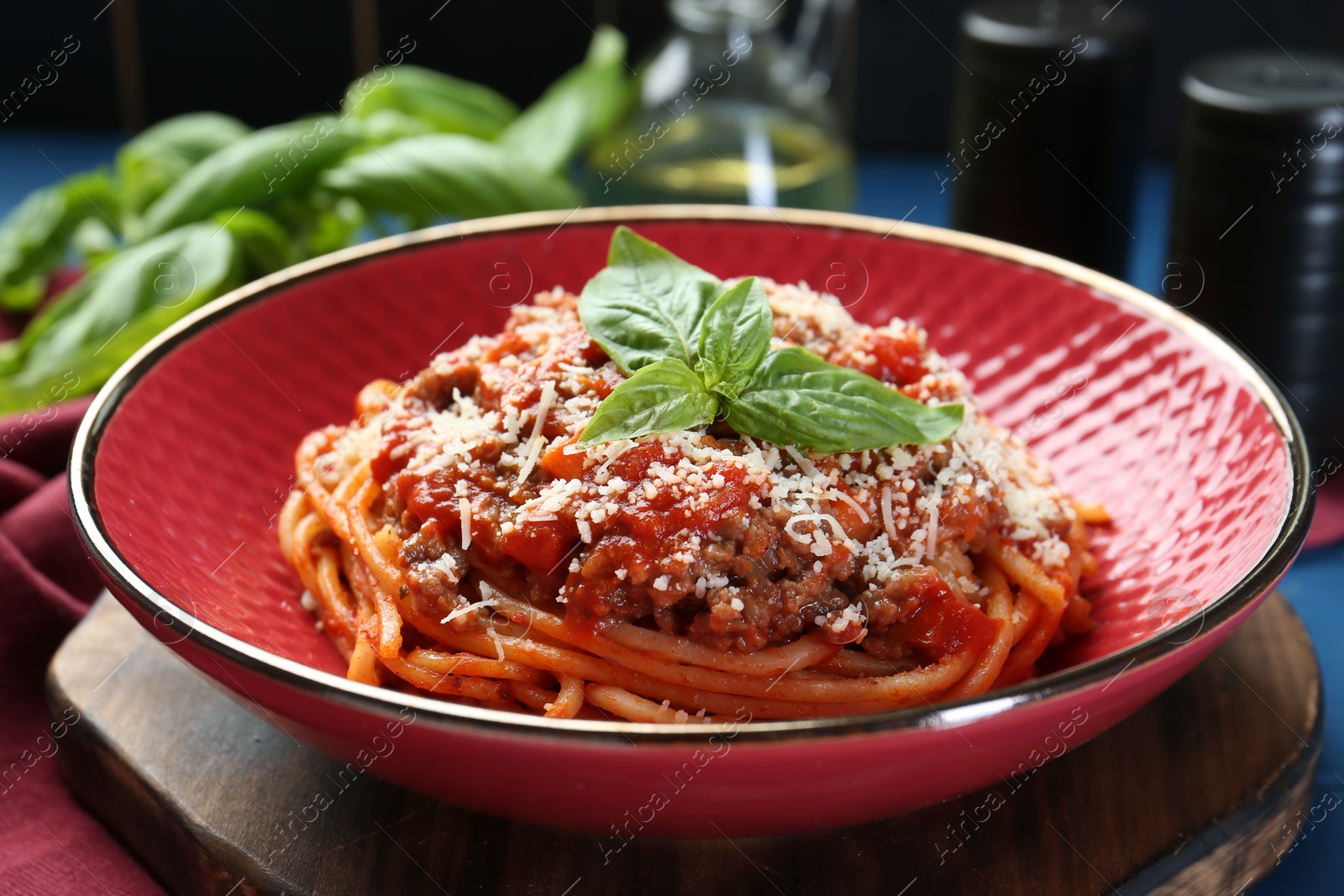 Photo of Delicious pasta bolognese with basil on table, closeup