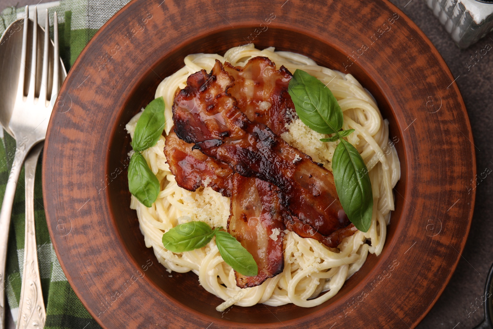 Photo of Delicious pasta Carbonara served on table, flat lay