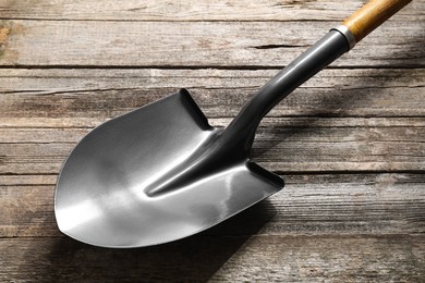 Photo of Metal shovel with handle on wooden table