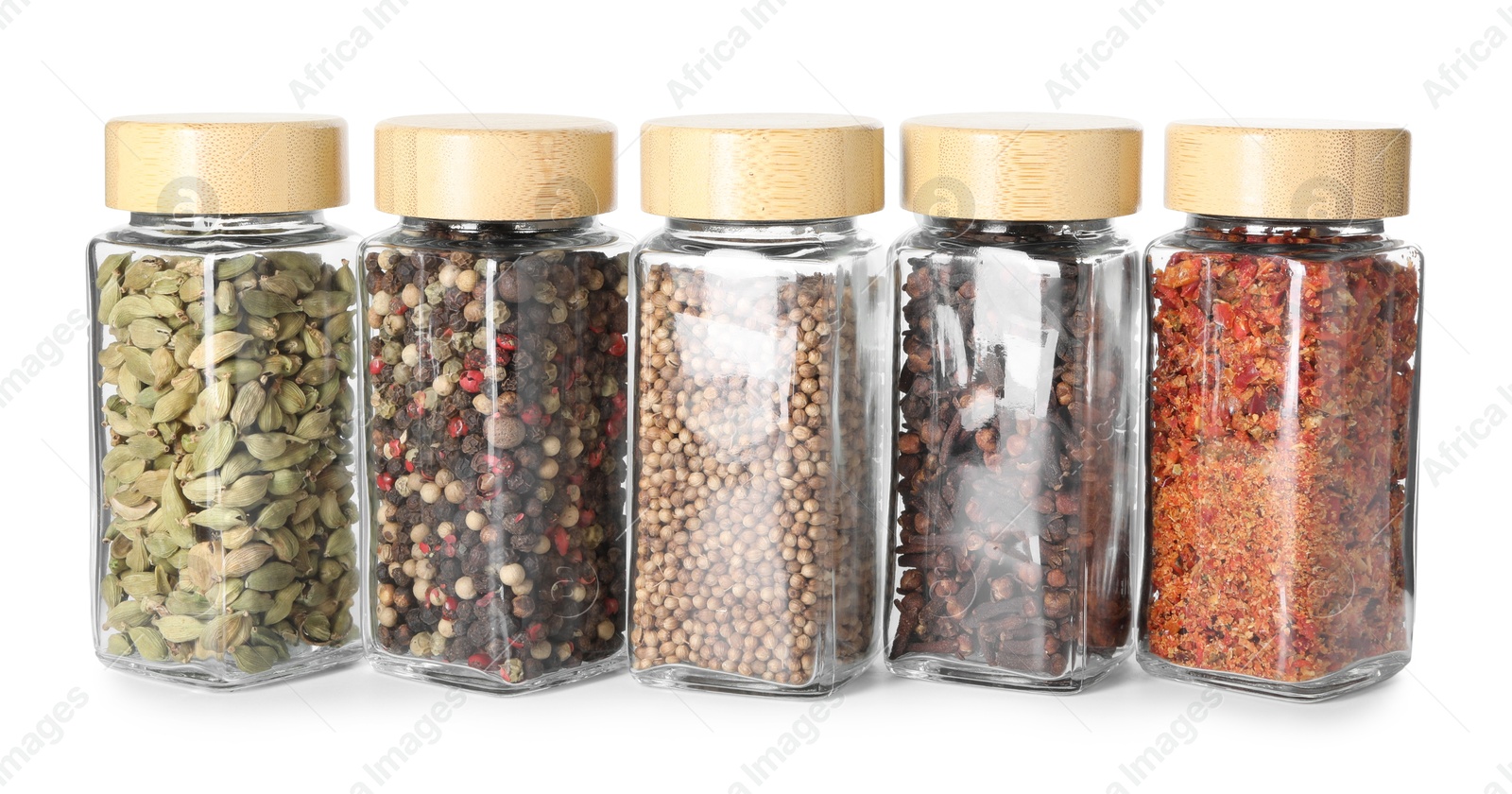 Photo of Different spices in glass jars isolated on white