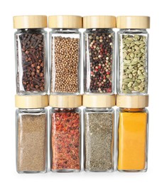 Photo of Different spices in glass jars isolated on white