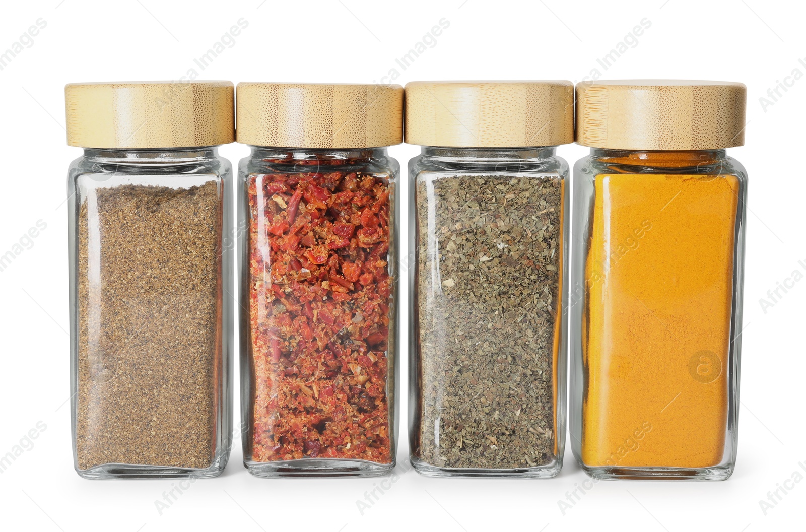 Photo of Different spices in glass jars isolated on white