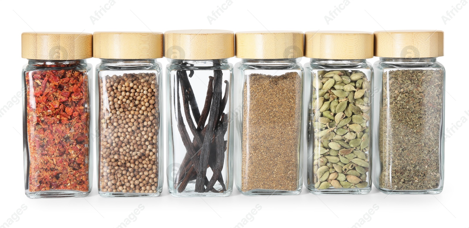 Photo of Different spices in glass jars isolated on white