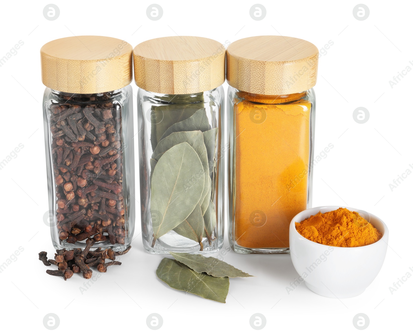 Photo of Different spices in glass jars isolated on white