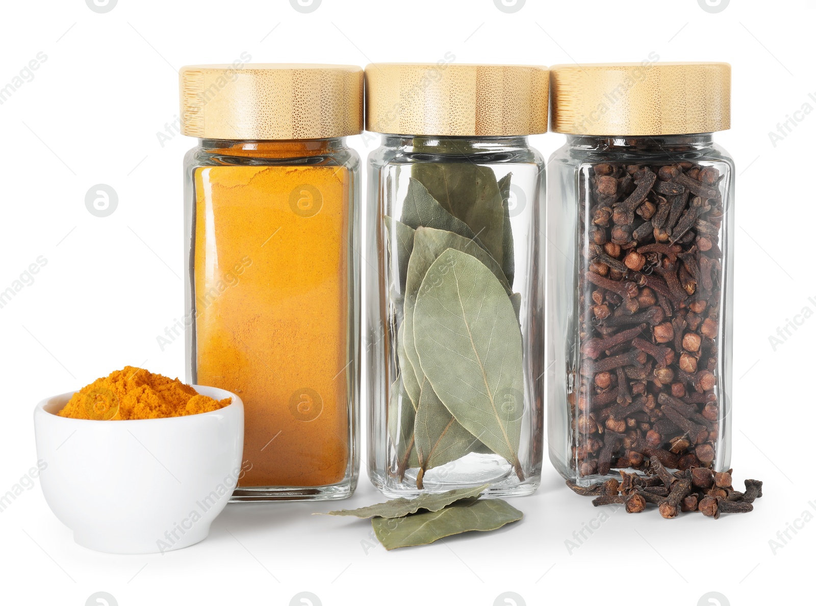 Photo of Different spices in glass jars isolated on white