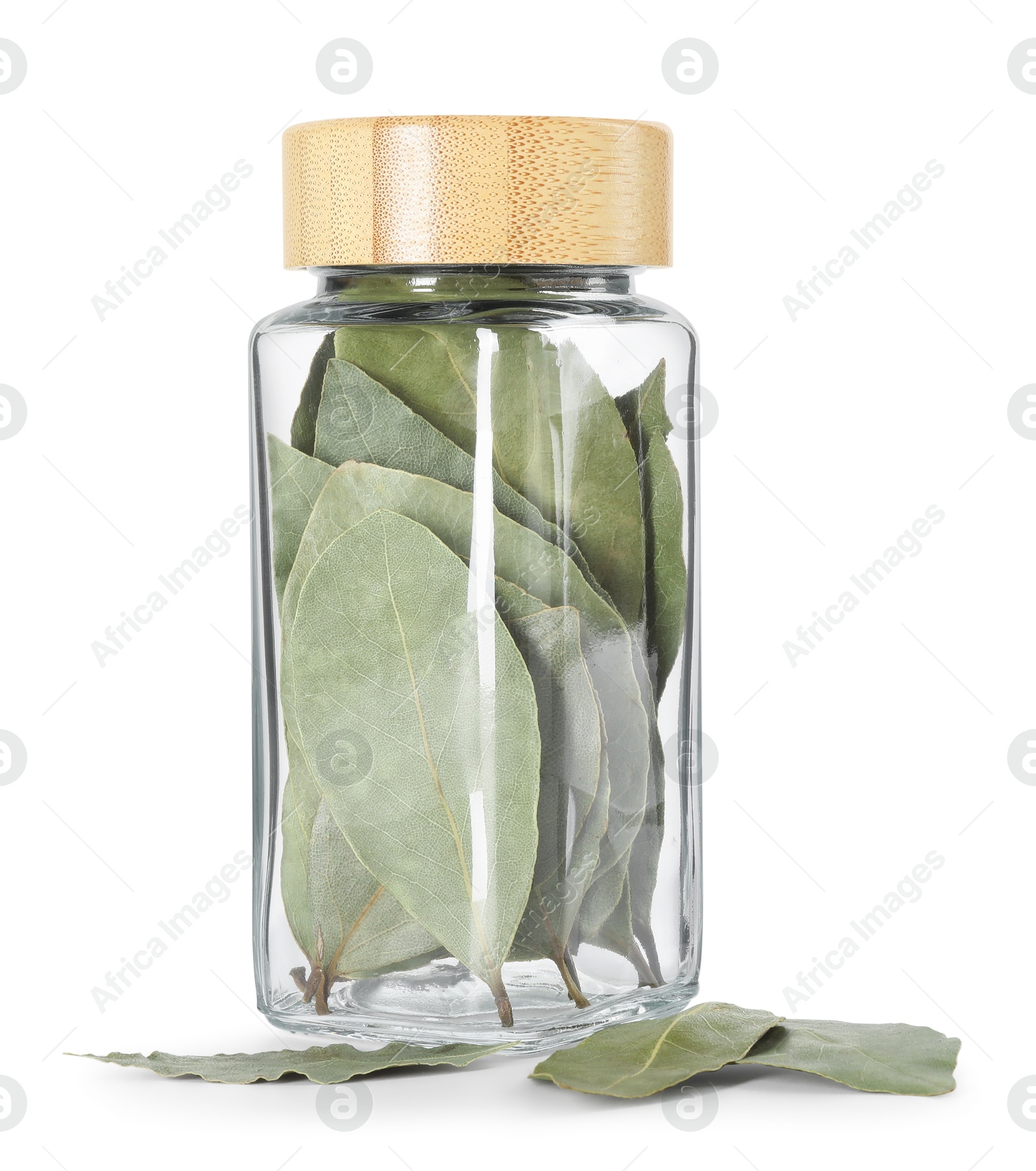 Photo of Dry bay leaves in glass jar isolated on white