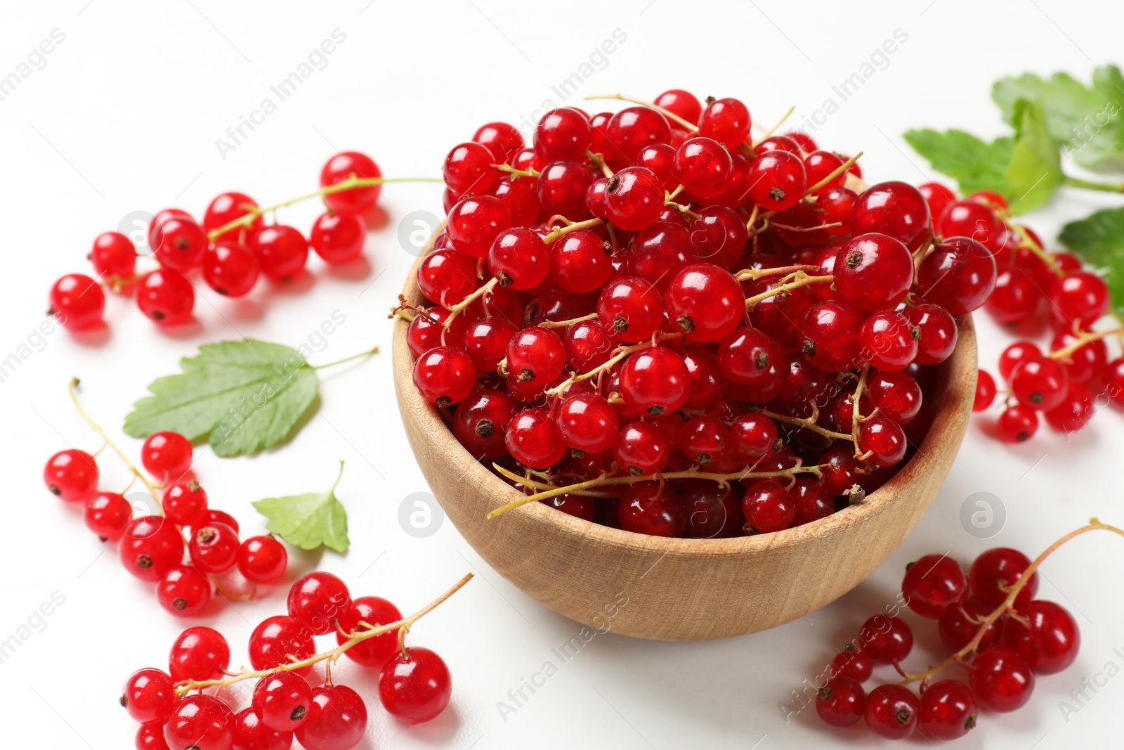 Photo of Fresh red currant berries in bowl on white table, closeup