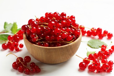 Photo of Fresh red currant berries in bowl on white table, closeup