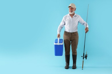 Fisherman with rod and cool box on light blue background