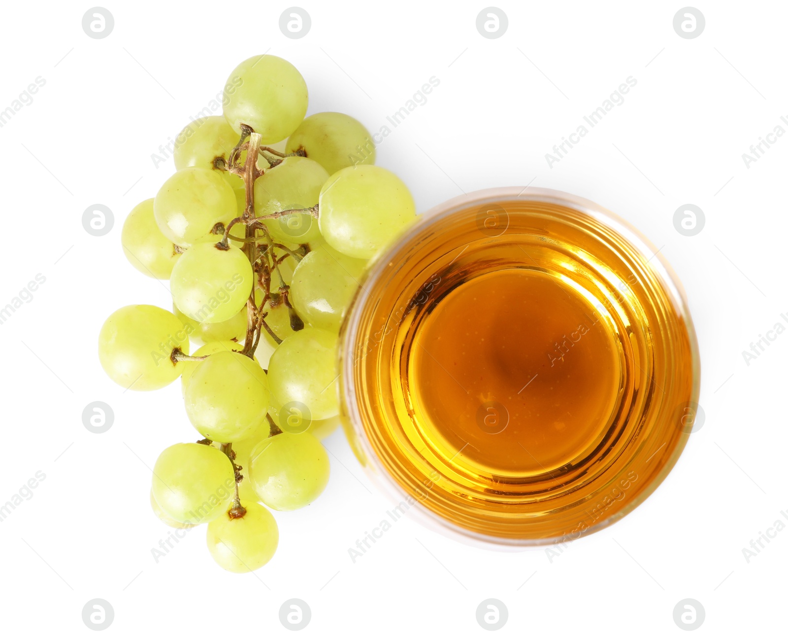 Photo of Tasty grape juice in glass and berries isolated on white, top view