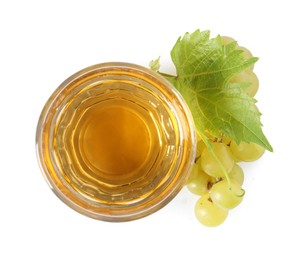 Photo of Ripe grapes and glass of tasty juice isolated on white, top view