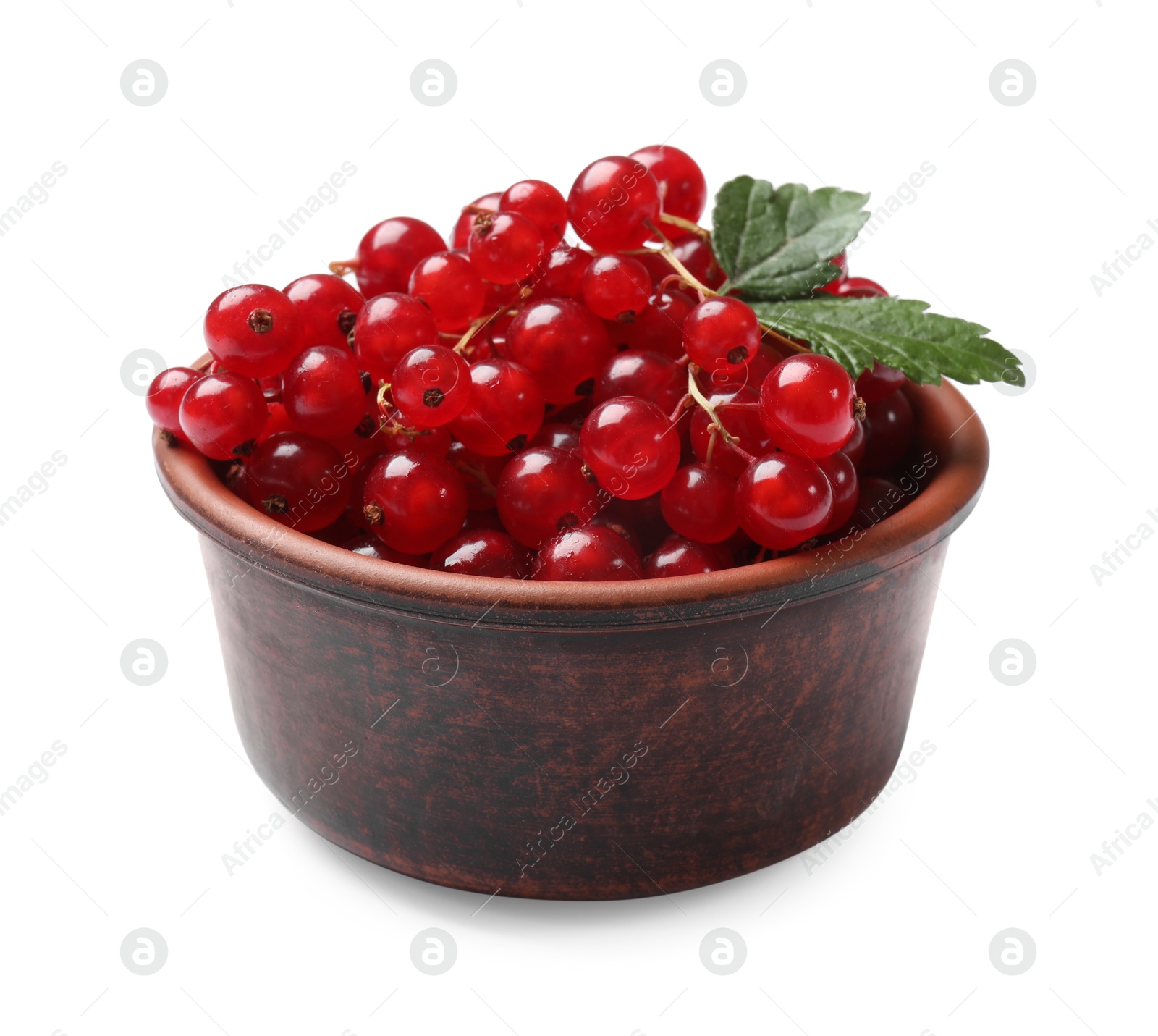 Photo of Ripe red currants with green leaves in bowl isolated on white