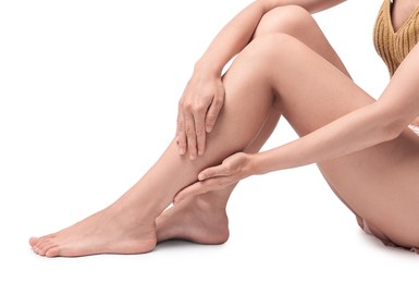 Photo of Woman touching her smooth legs on white background, closeup