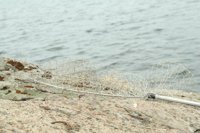 Photo of One landing net for fishing near lake