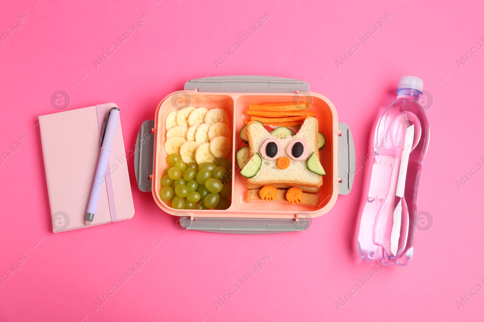 Photo of Lunch box with snacks, bottle of water and stationery on pink background, flat lay