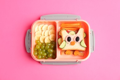 Photo of Lunch box with sandwich and fruits on pink background, top view