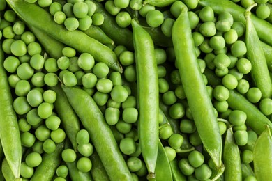 Photo of Many fresh green pods and peas as background, closeup