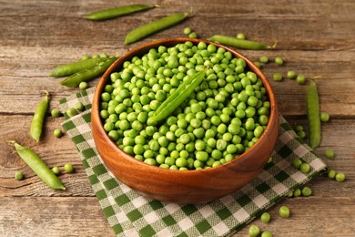 Fresh green peas and pods on wooden table