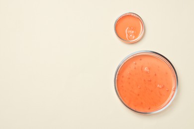 Petri dishes with samples on beige background, top view. Space for text