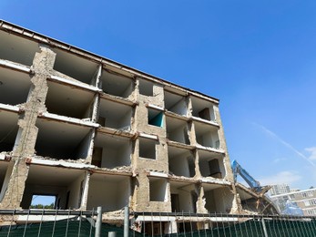 Demolition of building outdoors, low angle view