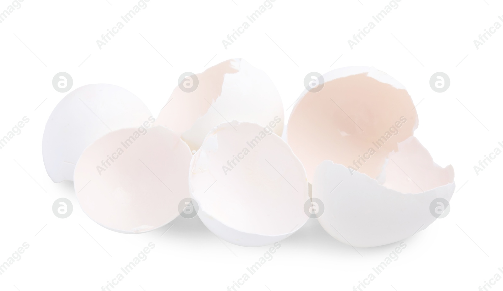 Photo of Pile of broken eggshells isolated on white