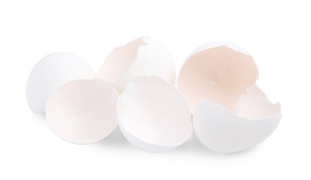 Photo of Pile of broken eggshells isolated on white