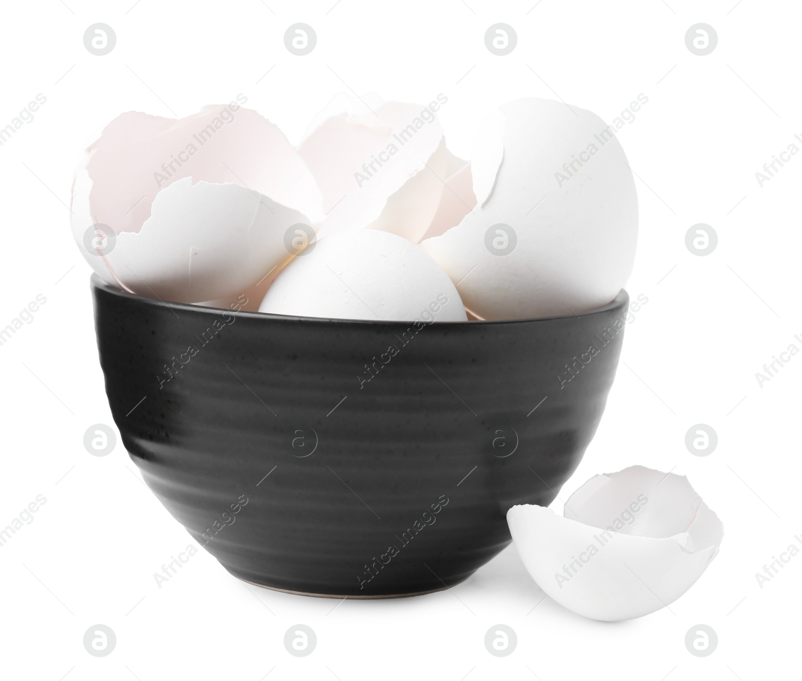 Photo of Broken eggshells in bowl isolated on white