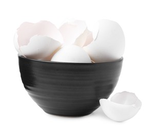 Photo of Broken eggshells in bowl isolated on white