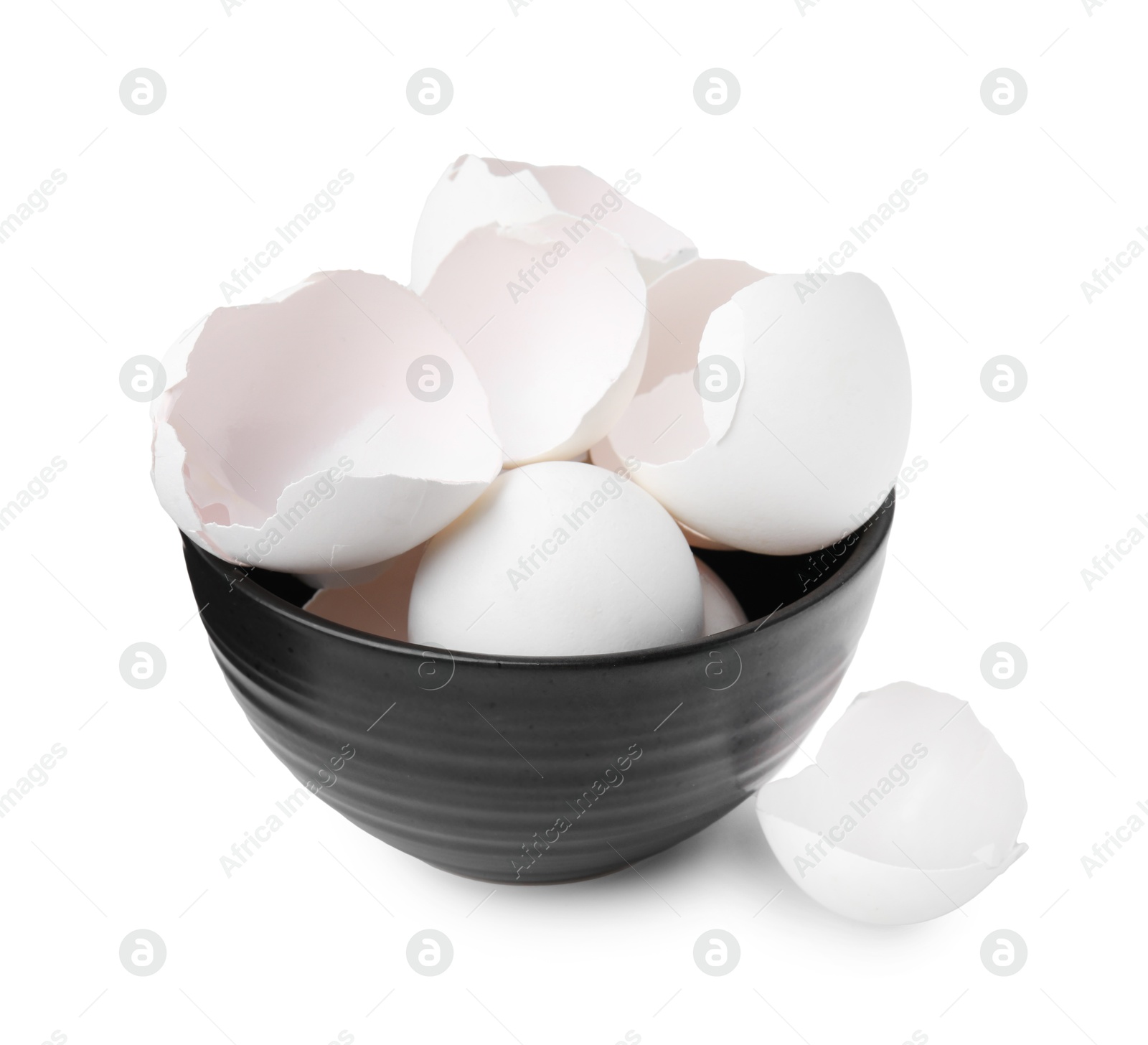 Photo of Broken eggshells in bowl isolated on white