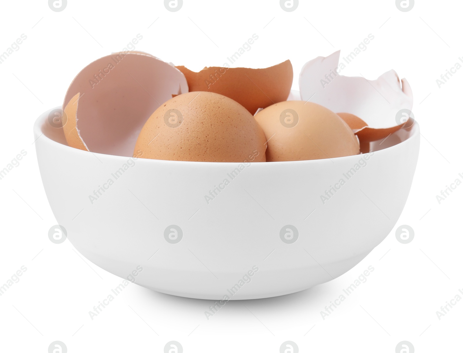 Photo of Broken eggshells in bowl isolated on white